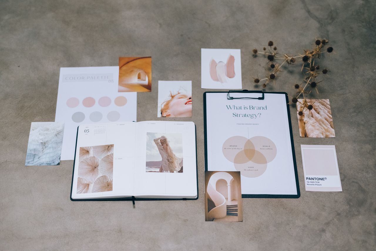 team-01 A flat lay of branding elements with color palettes and strategic planning documents on a concrete surface.
